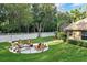 Backyard with a manicured lawn, patio with seating, and white vinyl fence at 11432 Savannah Lakes Dr, Parrish, FL 34219