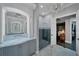 Bright bathroom featuring a shower, a marble vanity, and a decorative chandelier at 11432 Savannah Lakes Dr, Parrish, FL 34219