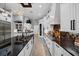 A gourmet kitchen with white cabinetry, granite counters, stainless steel appliances, and an island with a sink at 11432 Savannah Lakes Dr, Parrish, FL 34219