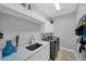 Laundry room featuring a sink and cabinets, and modern washer and dryer at 11432 Savannah Lakes Dr, Parrish, FL 34219