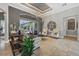 Bright living room with large windows overlooking the pool and patio, with elegant decor and tile flooring at 11432 Savannah Lakes Dr, Parrish, FL 34219
