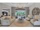 Bright, modern living room with view of the enclosed pool, neutral paint, and ample seating at 11432 Savannah Lakes Dr, Parrish, FL 34219