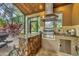 Outdoor kitchen featuring stone accents, stainless steel grill, and sink at 11432 Savannah Lakes Dr, Parrish, FL 34219