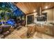 Luxurious outdoor kitchen and living area featuring a stone-clad grill station and tranquil water feature at 11432 Savannah Lakes Dr, Parrish, FL 34219