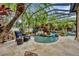 Tropical screened in pool and spa surrounded by lush plants and greenery at 11432 Savannah Lakes Dr, Parrish, FL 34219