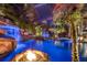 Amazing enclosed pool with rock features, waterfalls, lush landscaping, and a fire pit at 11432 Savannah Lakes Dr, Parrish, FL 34219