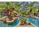 Relax in this beautiful enclosed pool with waterfalls, rock features and tropical plants at 11432 Savannah Lakes Dr, Parrish, FL 34219