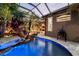 View of the pool area with rock waterfall feature and access to outdoor living at 11432 Savannah Lakes Dr, Parrish, FL 34219