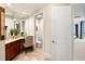 Bright bathroom with a vanity, toilet, and lots of storage space at 130 Riviera Dunes Way # 1104, Palmetto, FL 34221