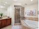 Luxurious bathroom featuring a soaking tub, separate shower, and dual vanity at 130 Riviera Dunes Way # 1104, Palmetto, FL 34221