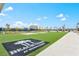 Beach Club featuring a beach with sand, palm trees, and green artificial grass at 130 Riviera Dunes Way # 1104, Palmetto, FL 34221