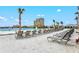 Beach front property featuring chairs, sand, palm trees, and a lagoon at 130 Riviera Dunes Way # 1104, Palmetto, FL 34221