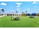 Relaxing community space featuring comfortable seating areas on manicured lawns and near a covered structure at 130 Riviera Dunes Way # 1104, Palmetto, FL 34221