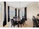 Dining room with black chairs, dark table, bright chandelier, and plenty of natural light at 130 Riviera Dunes Way # 1104, Palmetto, FL 34221