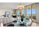 Bright living area with a dining table, comfortable seating, and a scenic waterfront view at 130 Riviera Dunes Way # 1104, Palmetto, FL 34221