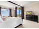 Comfortable main bedroom boasts beautiful views and a peaceful sitting area at 130 Riviera Dunes Way # 1104, Palmetto, FL 34221