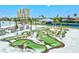 An aerial view of a miniature golf course with palm trees and beautiful landscaping near the community at 130 Riviera Dunes Way # 1104, Palmetto, FL 34221