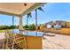 Outdoor kitchen features granite countertops, a built-in sink and stainless steel appliances at 130 Riviera Dunes Way # 1104, Palmetto, FL 34221
