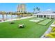 Artificial grass outdoor space featuring tables, chairs, hammocks, and games at 130 Riviera Dunes Way # 1104, Palmetto, FL 34221