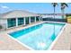 Lap pool featuring clear water and views of the clubhouse with lake view at 130 Riviera Dunes Way # 1104, Palmetto, FL 34221