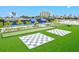 Community recreation area with checker boards, bocce court, tennis court, and condominium building at 130 Riviera Dunes Way # 1104, Palmetto, FL 34221