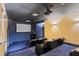 Home theater featuring comfortable seating, a projector, and a large screen at 130 Riviera Dunes Way # 1104, Palmetto, FL 34221