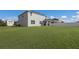 Expansive backyard features lush green grass and a white fence at 15404 Trinity Fall Way, Bradenton, FL 34212