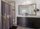 Bathroom features dual vanity, shower and tile surround at 15404 Trinity Fall Way, Bradenton, FL 34212