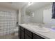 Bathroom showcases a dual sink vanity and tiled flooring at 15404 Trinity Fall Way, Bradenton, FL 34212