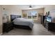 Cozy bedroom featuring a ceiling fan, neutral paint, and wood-look floors at 15404 Trinity Fall Way, Bradenton, FL 34212