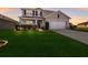 Charming two-story home showcasing a lush green lawn and well-maintained landscaping at 15404 Trinity Fall Way, Bradenton, FL 34212