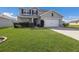 Well-maintained two-story home with a manicured front yard and two car garage at 15404 Trinity Fall Way, Bradenton, FL 34212