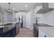 Modern kitchen featuring stainless steel appliances, white cabinets, and stylish fixtures at 15404 Trinity Fall Way, Bradenton, FL 34212
