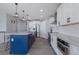 Modern kitchen with a large island, stainless steel appliances, and stylish pendant lighting at 15404 Trinity Fall Way, Bradenton, FL 34212