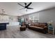 Open living space featuring wood-look floors, a ceiling fan, and comfortable seating at 15404 Trinity Fall Way, Bradenton, FL 34212