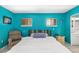 Bedroom featuring bright blue walls, two windows, a ceiling fan, and tile flooring at 327 Hernando Ave, Sarasota, FL 34243