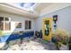 Stylish courtyard featuring pebble ground cover, tiled accents, bright yellow door and plenty of sunlight at 327 Hernando Ave, Sarasota, FL 34243