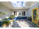 Charming courtyard with unique decor, blue tiled accent, and a welcoming yellow door at 327 Hernando Ave, Sarasota, FL 34243