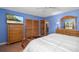 Main bedroom with television, ample closet space, and ensuite bathroom entrance at 327 Hernando Ave, Sarasota, FL 34243
