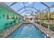 Inviting screened-in pool with brick coping, patio furniture, and serene backyard views at 327 Hernando Ave, Sarasota, FL 34243