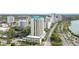 This is an aerial view of a high-rise condominium building in an urban area, surrounded by lush greenery at 340 S Palm Ave # Pl1, Sarasota, FL 34236