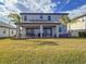 Exterior elevation with backyard, covered patio, and manicured lawn at 3704 Wild Blossom Pl, Parrish, FL 34219