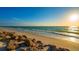 Beautiful beach view with rocks and waves, perfect for relaxation and enjoying the sunset at 3858 Casey Key, Nokomis, FL 34275