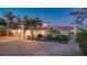 Stunning two-story home featuring a brick driveway, arched entryway, and lush tropical landscaping at 3858 Casey Key, Nokomis, FL 34275