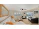 Cozy living room with comfortable seating, ceiling fan, and sliding glass doors leading to the pool at 3858 Casey Key, Nokomis, FL 34275