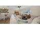 Inviting living room with large sectional sofa, woven chairs, and lots of natural light at 3858 Casey Key, Nokomis, FL 34275