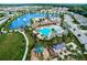 Aerial view showcases the pool, clubhouse, and community pond with fountain at 452 Tierra Verde Way, Bradenton, FL 34212