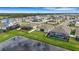 Aerial view of homes with screened patios and a community pool, situated next to a peaceful pond at 452 Tierra Verde Way, Bradenton, FL 34212