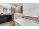 Bathroom showcasing a soaking tub, frameless shower, and granite countertop at 452 Tierra Verde Way, Bradenton, FL 34212