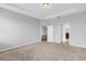 Neutral bedroom with tray ceiling, carpet flooring, and doorways to other rooms at 452 Tierra Verde Way, Bradenton, FL 34212